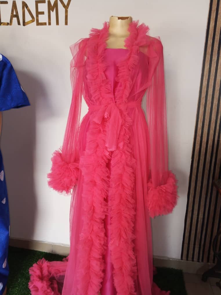 Tulle dressing gown designed for maternity photoshoot or special occasions featuring sheer puffy sleeves and ruffle details.